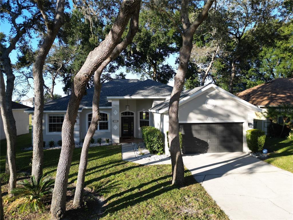 2560 Tall Maple Loop Ocoee, FL 34761 - Photo 4 of 32 a front view of a house with garden