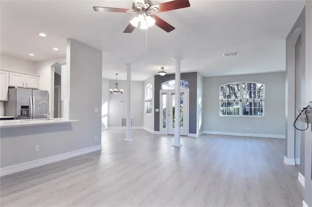 a view of kitchen with stainless steel appliances refrigerator stove microwave and cabinets