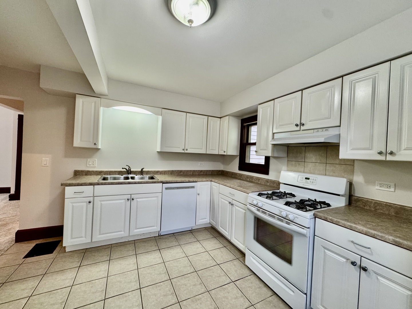 2506 Green Bay Road, Unit 2 Highland Park, IL 60035 - Photo 6 of 11 a kitchen with granite countertop white cabinets a sink dishwasher and a stove with wooden floor