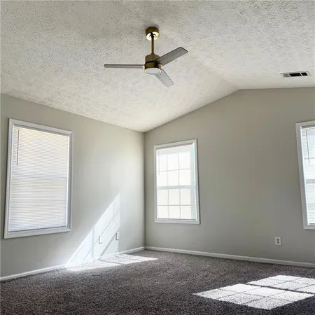 a view of a livingroom with wooden floor and a window