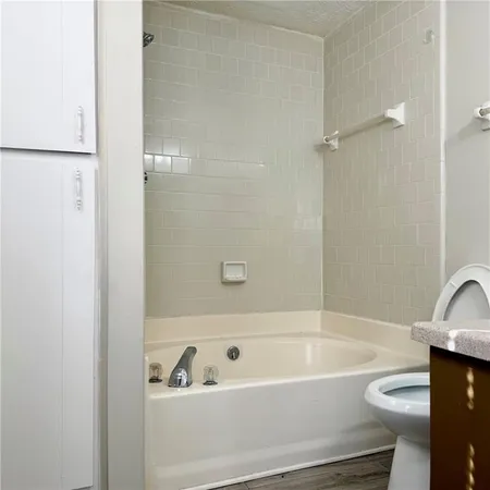 a bathroom with a bathtub and toilet