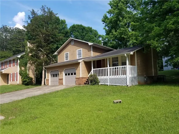 a view of a house with a yard and deck