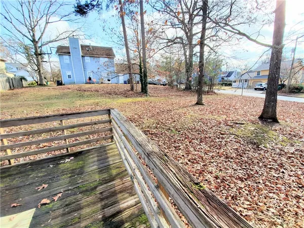 a view of a yard with wooden fence