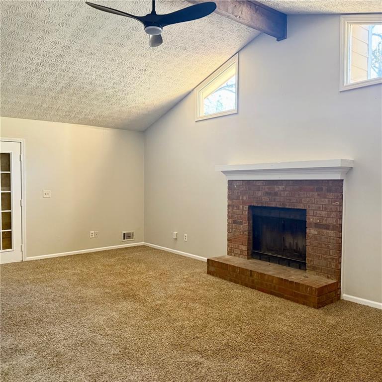 524 Julius Drive Stone Mountain, GA 30087 - Photo 3 of 17 a view of an empty room with a fireplace and a window