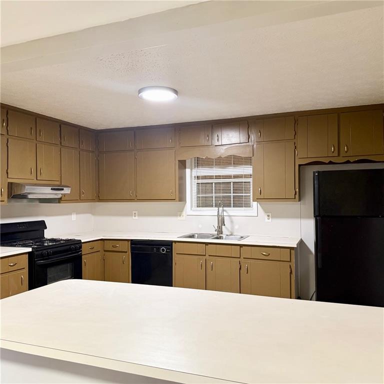 524 Julius Drive Stone Mountain, GA 30087 - Photo 7 of 17 a large kitchen with cabinets table and chairs