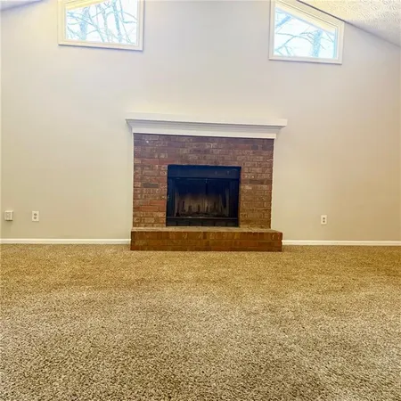 a view of empty room with a fireplace