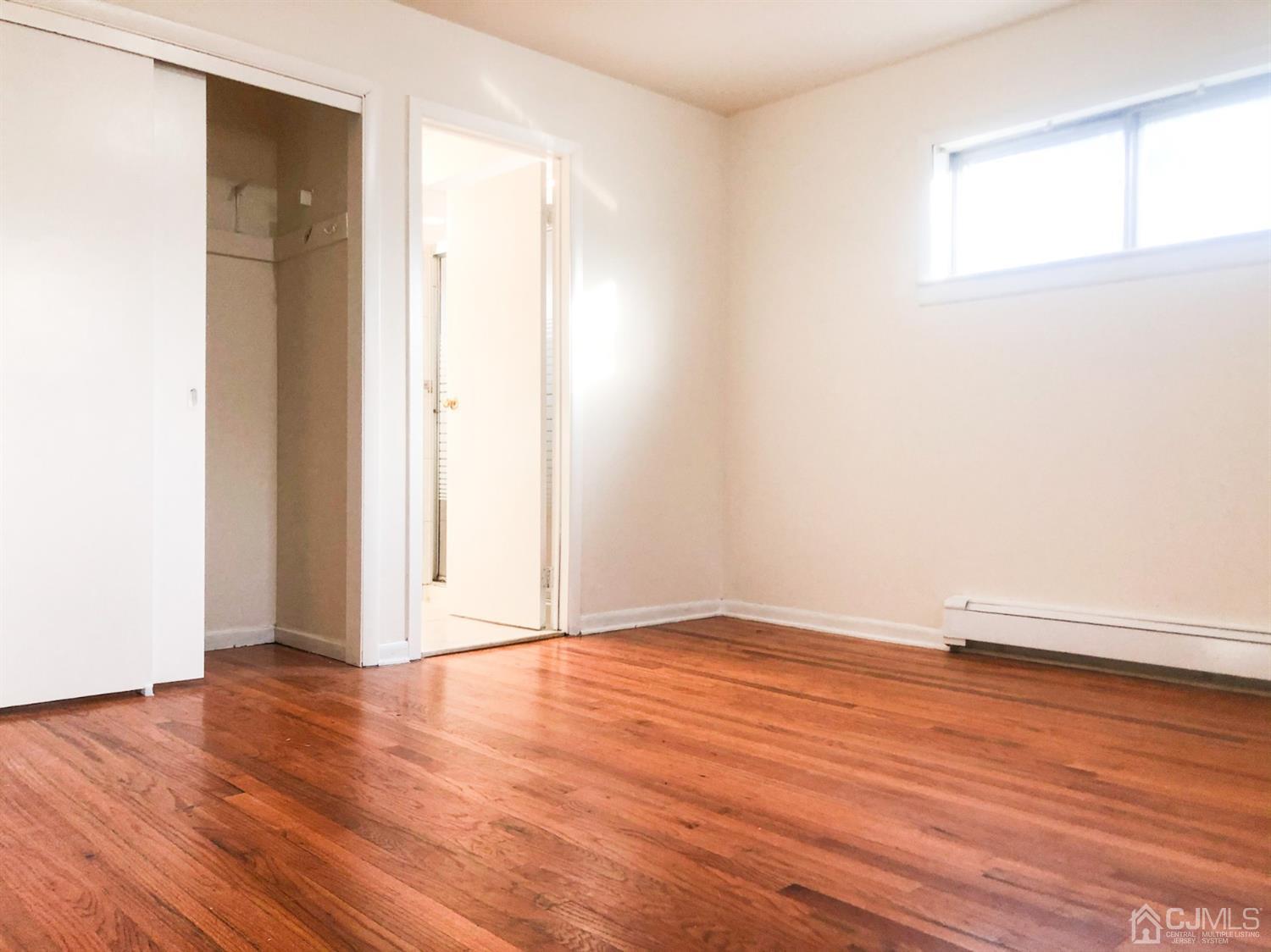 5 Brookside Road Edison, NJ 08817 - Photo 11 of 20 an empty room with wooden floor and windows
