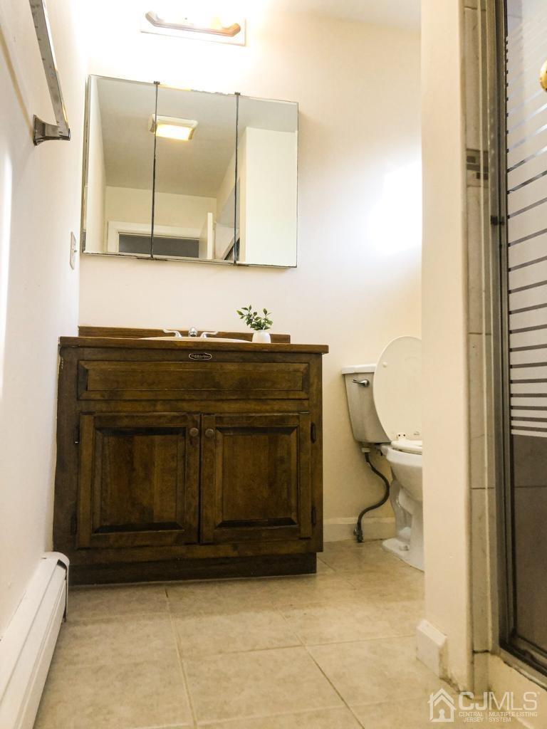 5 Brookside Road Edison, NJ 08817 - Photo 12 of 20 a bathroom with a sink a toilet and a mirror