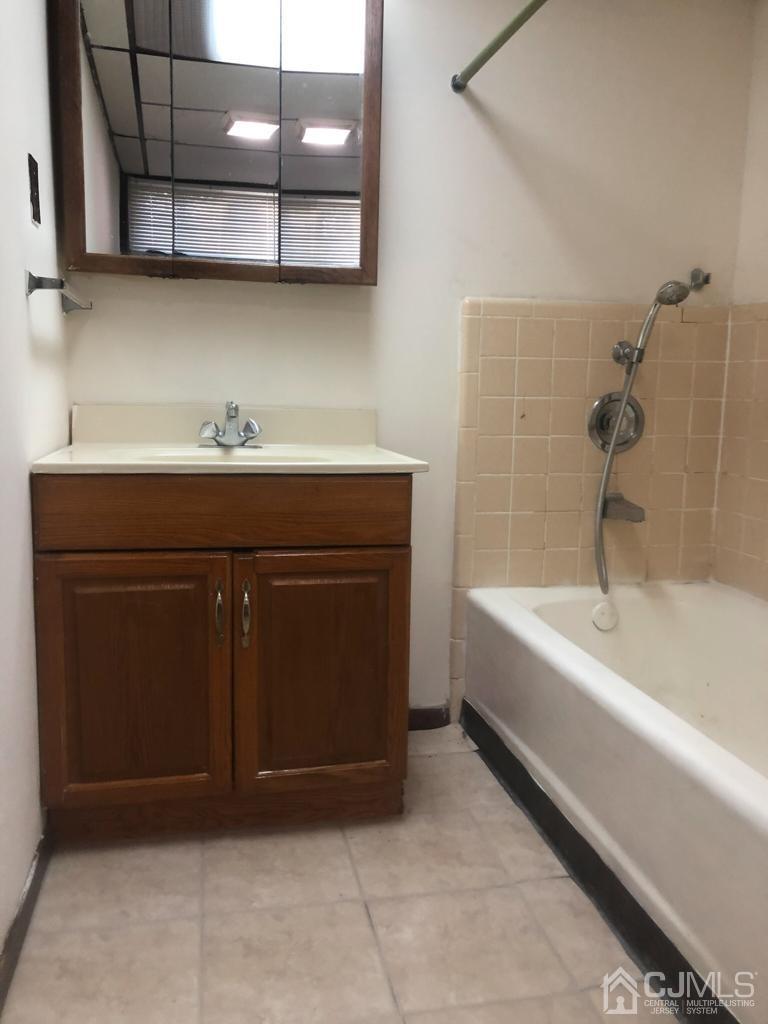 5 Brookside Road Edison, NJ 08817 - Photo 14 of 20 a bathroom with a sink and a bathtub