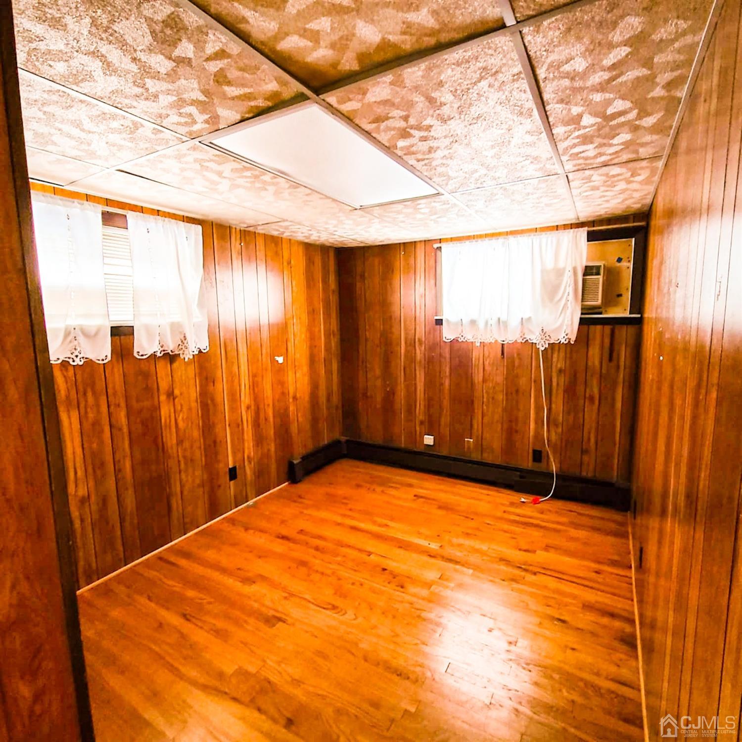 5 Brookside Road Edison, NJ 08817 - Photo 16 of 20 a view of a room with a large tree and wooden walls