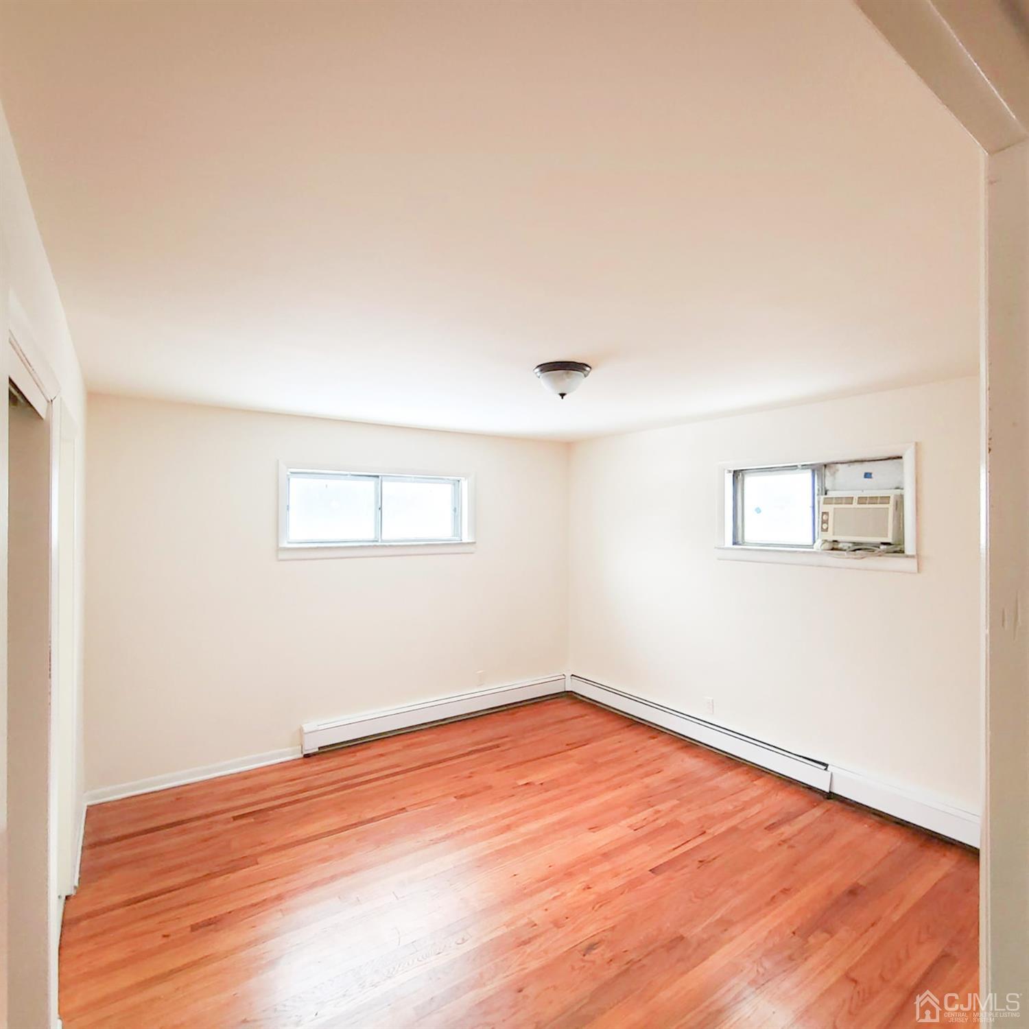 5 Brookside Road Edison, NJ 08817 - Photo 9 of 20 an empty room with wooden floor and windows