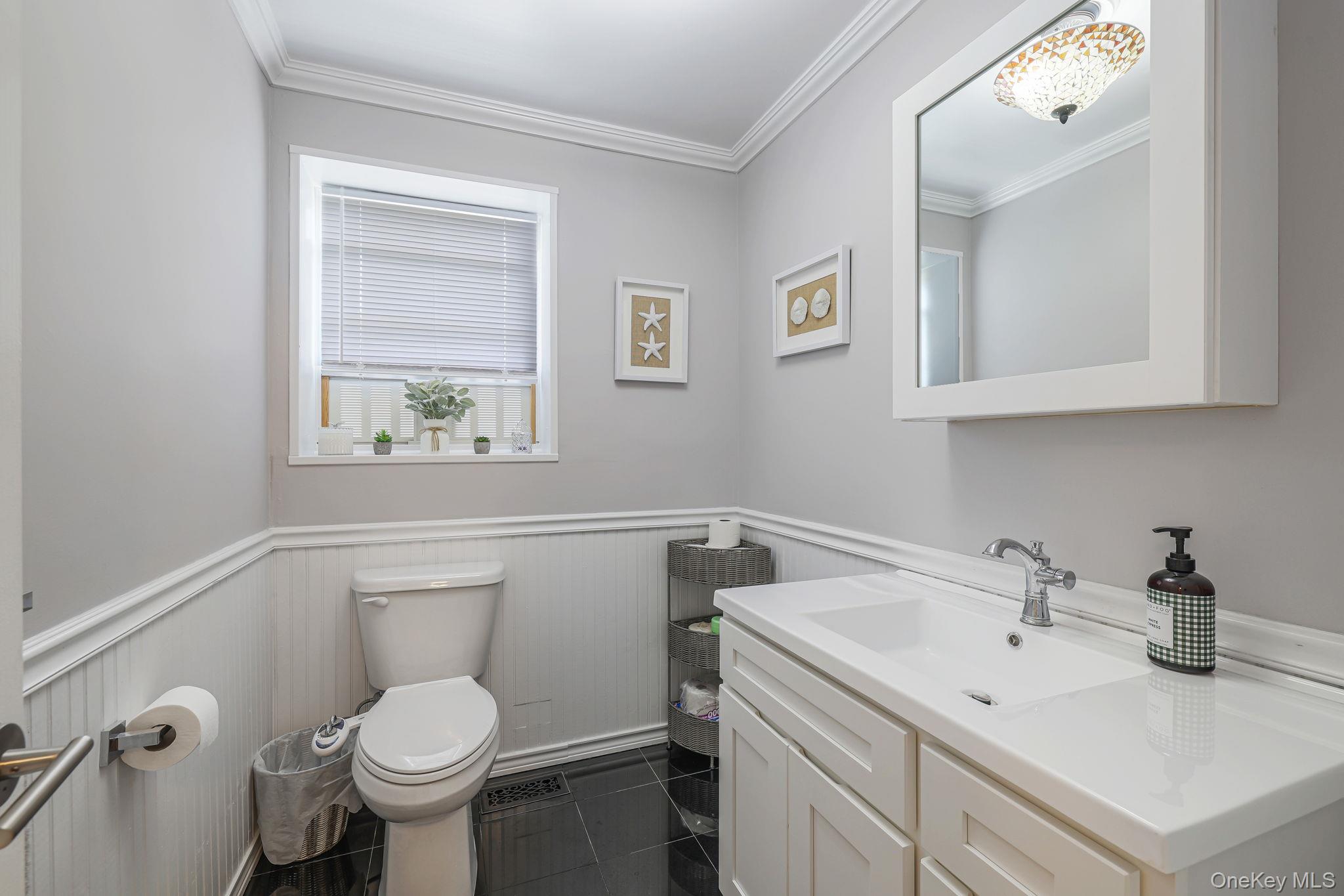 23 Cooley Road Parksville, NY 12768 - Photo 20 of 49 White vanity with integrated sink, chrome faucet, and a wall-mounted mirrored cabinet