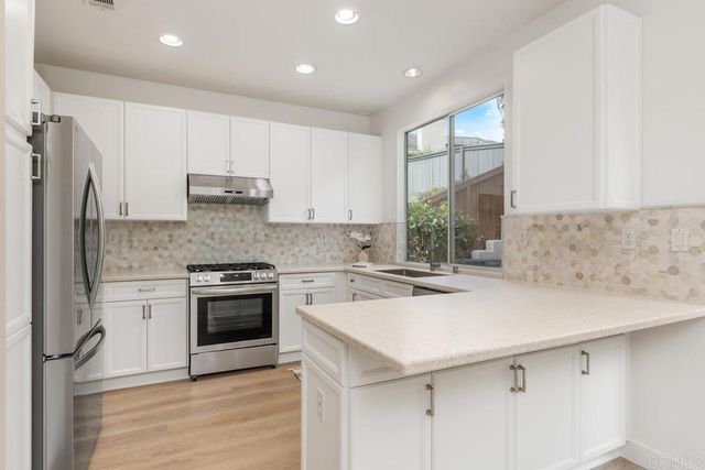 a kitchen with a sink a stove and refrigerator