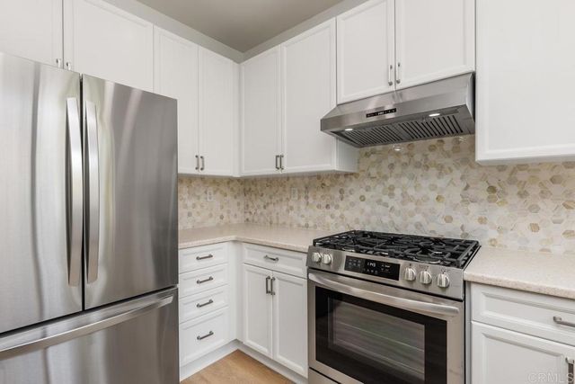 a kitchen with cabinets and stainless steel appliances