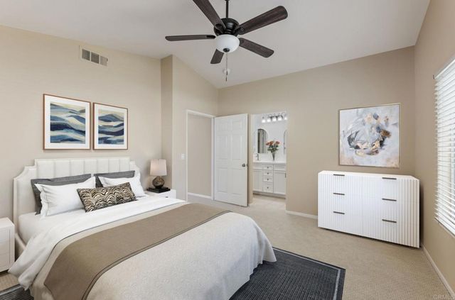 a bedroom with a bed and a painting on the wall