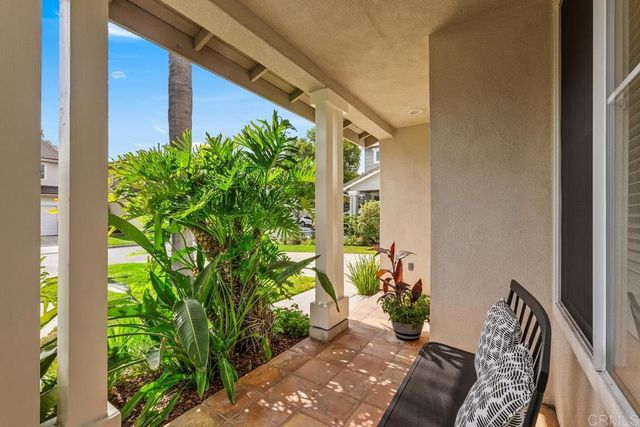 a view of a backyard with chair potted plants