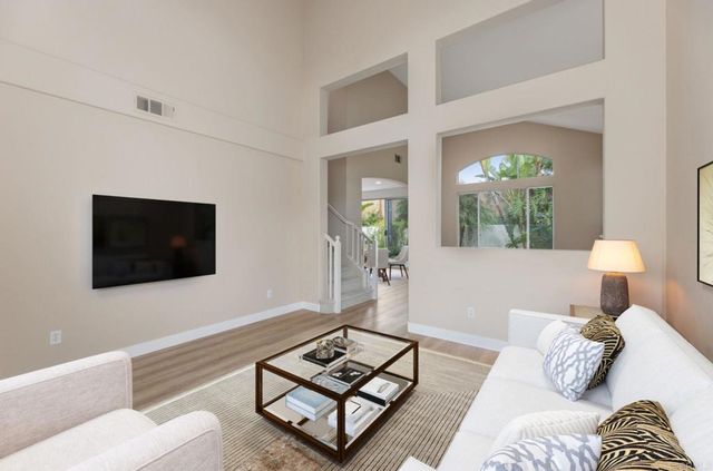 a living room with furniture a window and a flat screen tv