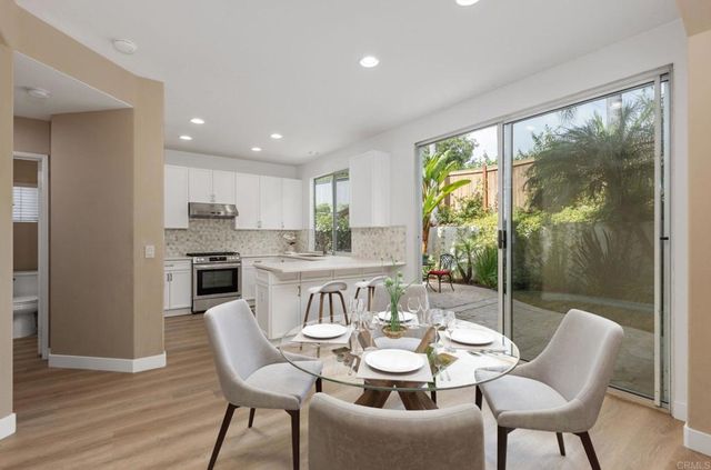 a view of a dining room with furniture a livingroom and wooden floor