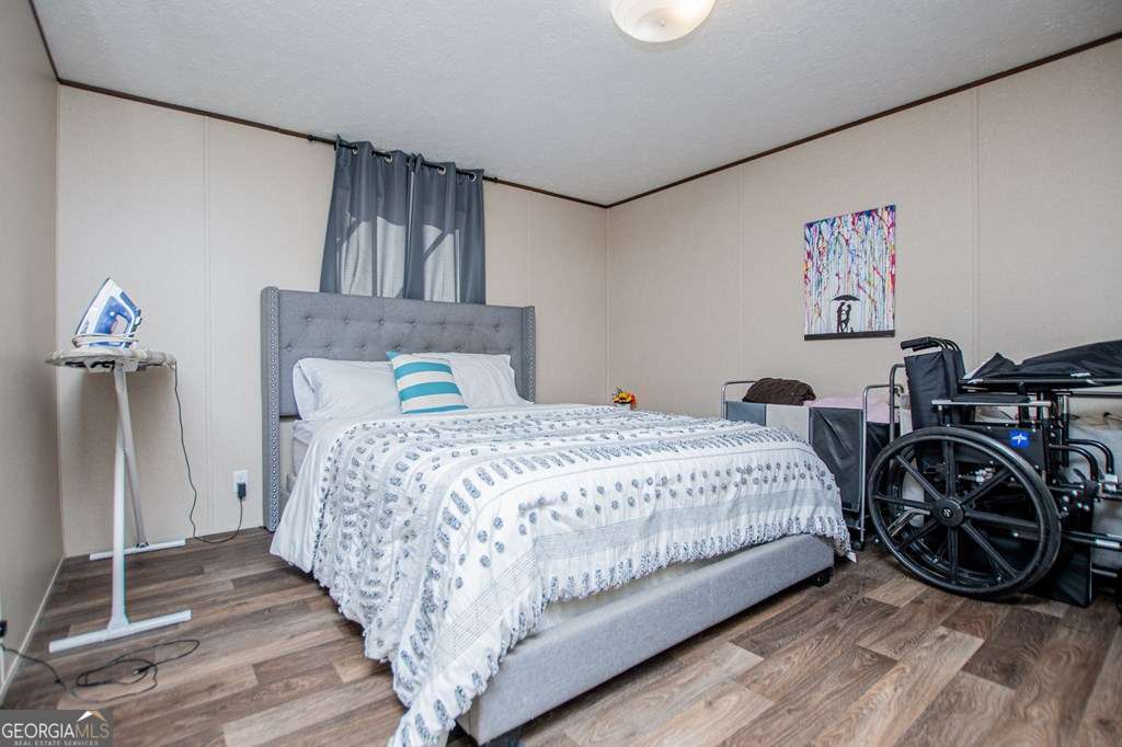 450 Glenloch Road Roopville, GA 30170 - Photo 24 of 38 a bedroom with a bed and a large mirror on the dresser