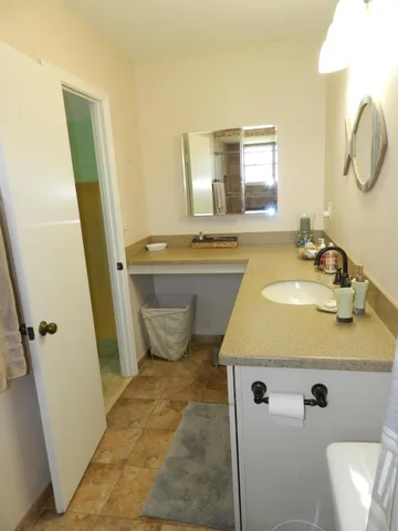 a bathroom with a sink toilet and mirror