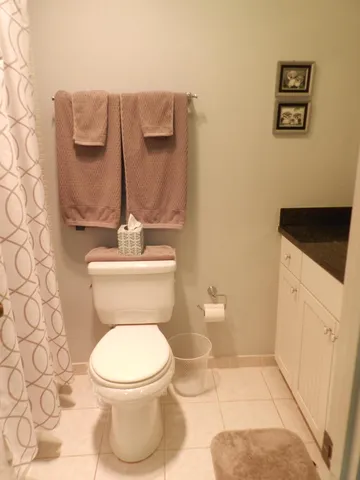 a white toilet sitting next to a bathroom sink