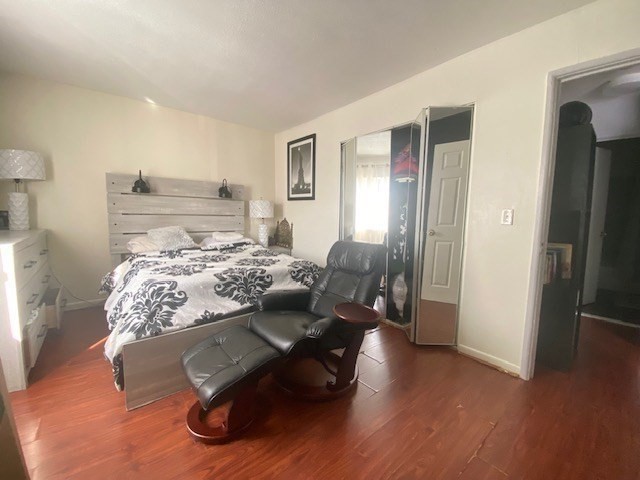 7 Weld Street, Unit 50 Framingham, MA 01702 - Photo 12 of 19 a bedroom with furniture and a wooden floor