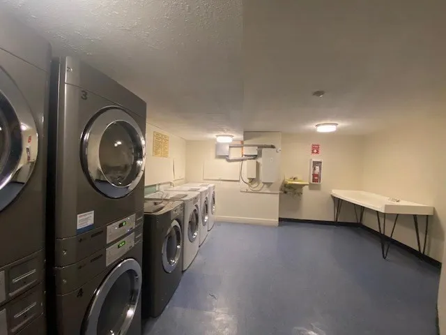 a view of a storage and utility room with washer and dryer