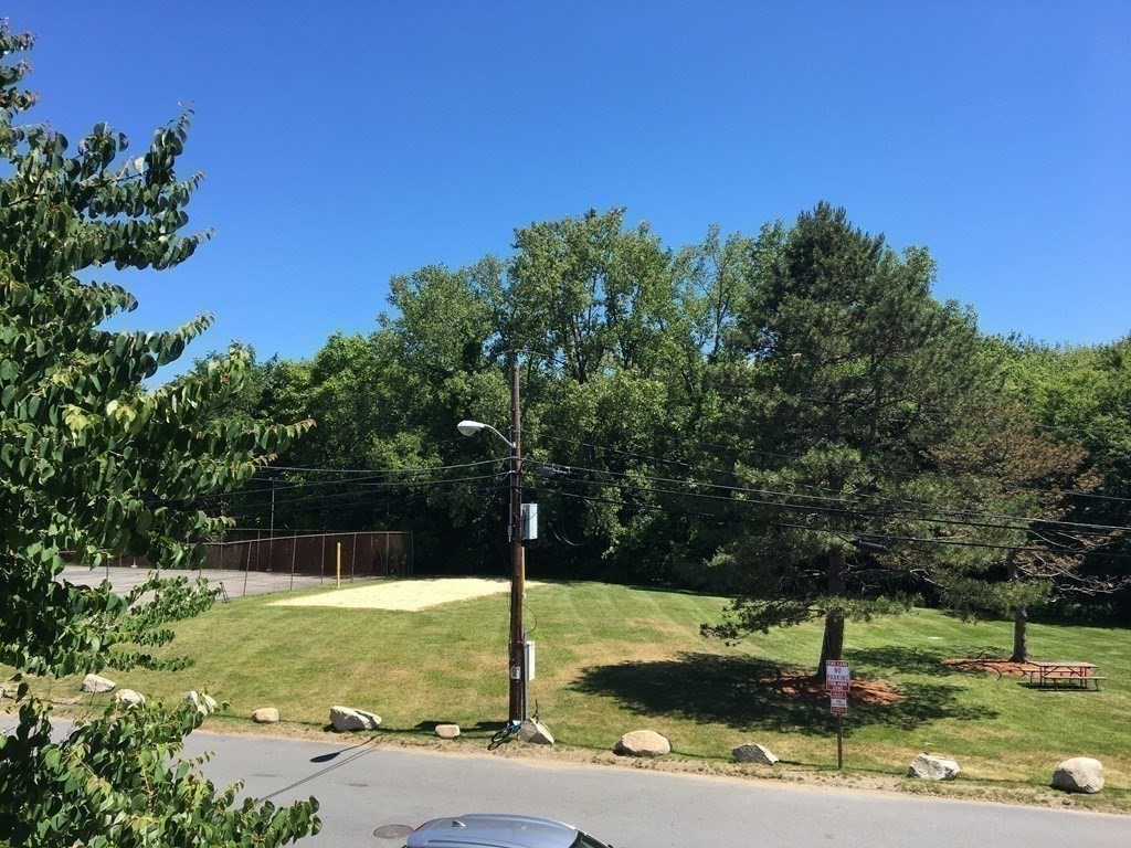 7 Weld Street, Unit 50 Framingham, MA 01702 - Photo 18 of 19 a view of a garden with a tree