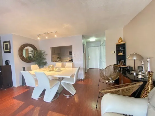 a view of a dining room with furniture and a chandelier