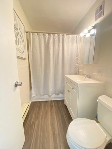 7 Weld Street, Unit 50 Framingham, MA 01702 - Photo 10 of 19 a white toilet sitting next to a bathroom sink