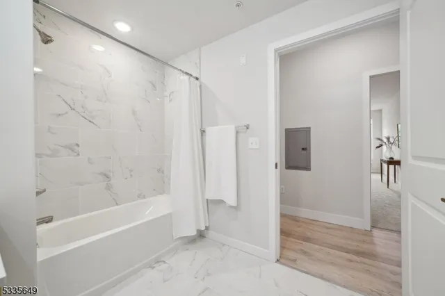 a bathroom with a bathtub and a shower