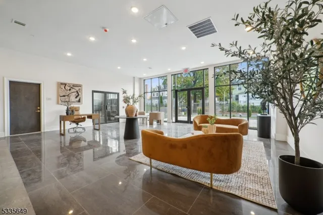 a living room with fireplace furniture and a large window