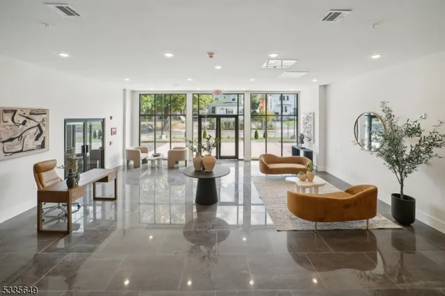 a living room with fireplace furniture and a large window