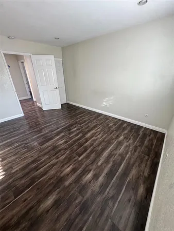 a view of a room with wooden floor and window