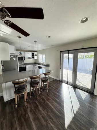 a outdoor space with lots of wooden furniture and stainless steel appliances