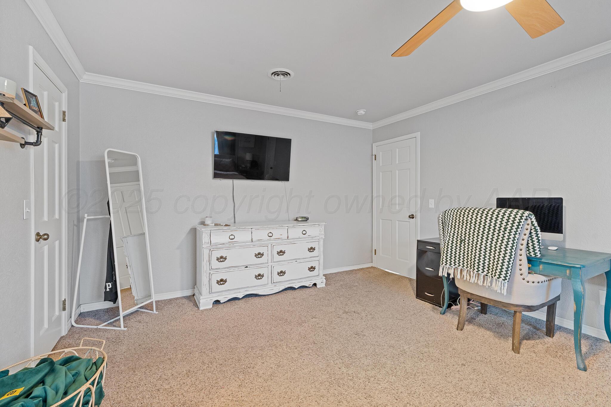 7602 Canode Drive Amarillo, TX 79121 - Photo 15 of 26 a living room with furniture and a flat screen tv