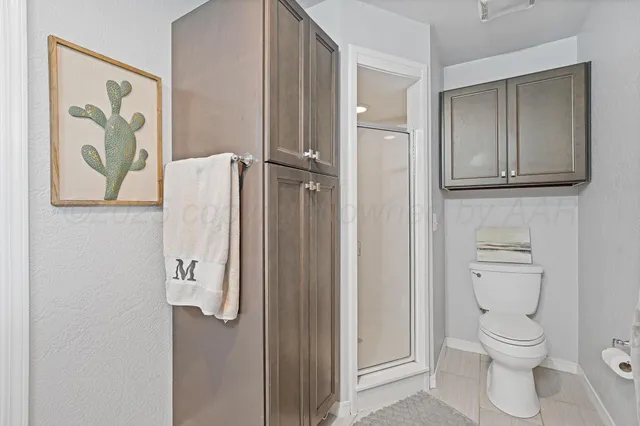 a bathroom with a toilet and a shower