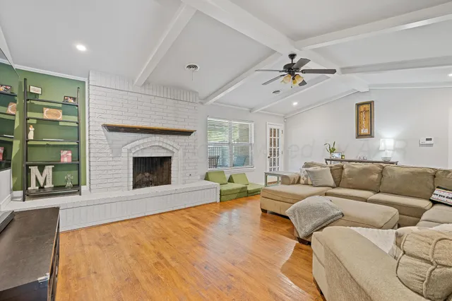 a living room with furniture and a fireplace