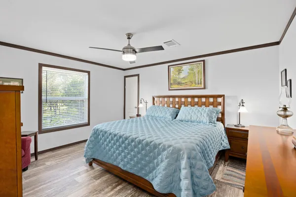 a bedroom with a large bed and a window