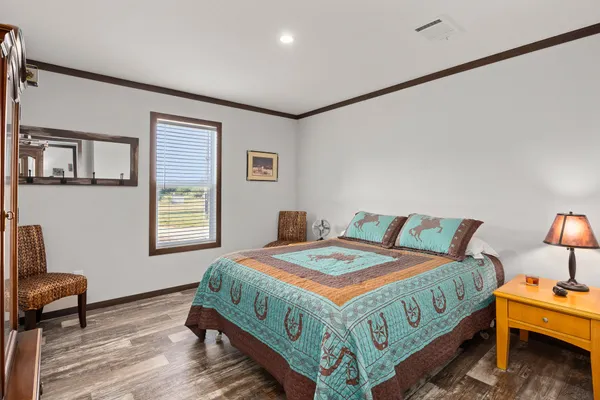 a bedroom with a bed a table and chair