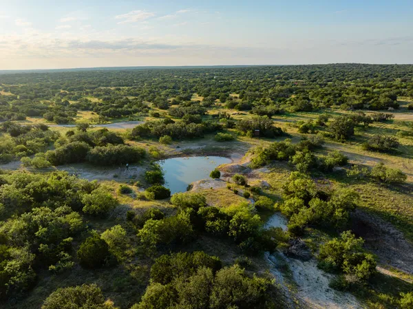 an aerial view of residential houses with city view