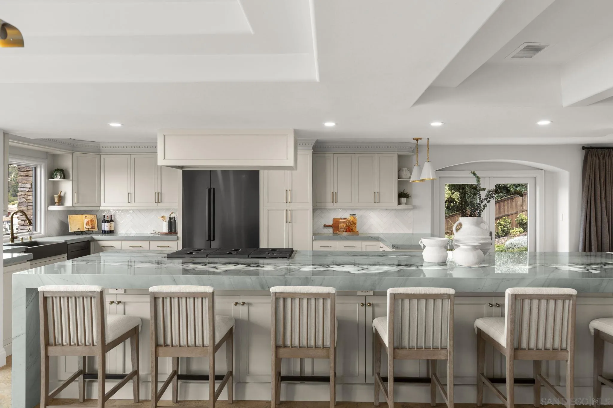 1542 El Paso Real La Jolla, CA 92037 - Photo 8 of 30 a kitchen with kitchen island granite countertop wooden cabinets and dining table
