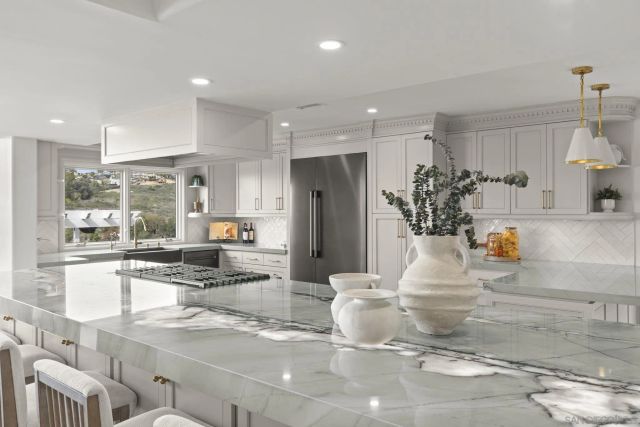 a living room with furniture and a view of kitchen