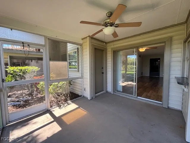 a view of empty room with floor to ceiling windows and wooden floor