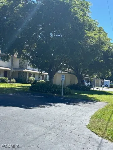 a front view of a house with a yard and swimming pool