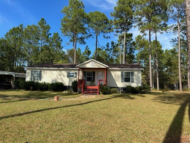 60 Magnolia Court Freeport, FL 32439 - Photo 1 of 29 a front view of a house with a yard and trees