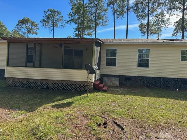 60 Magnolia Court Freeport, FL 32439 - Photo 15 of 29 a view of a house with a large window and a yard