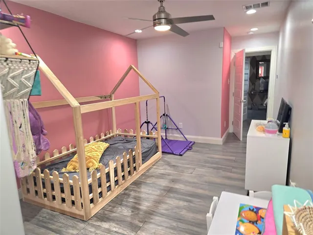 a bedroom with bed and a chandelier