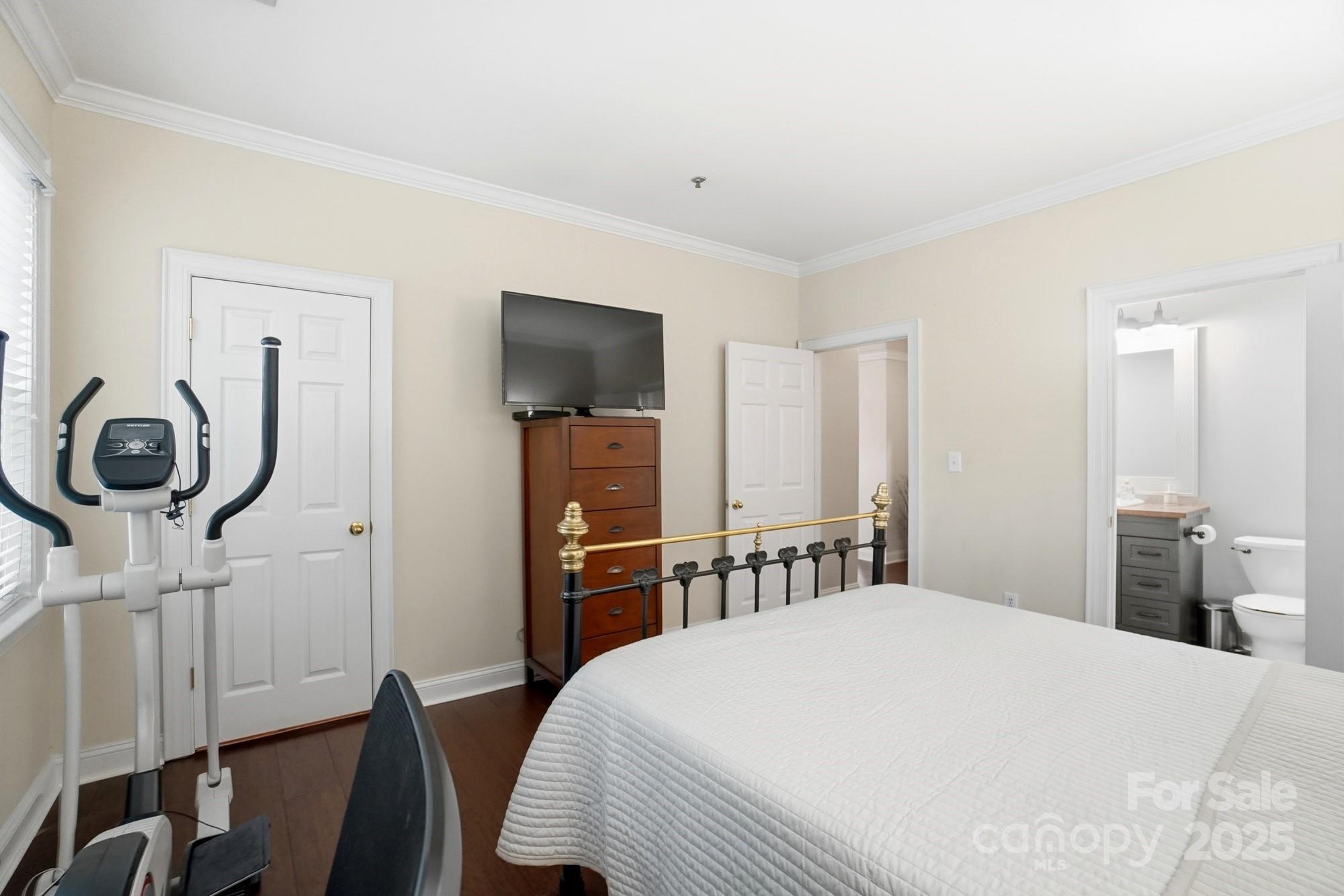 5617 Fairview Road, Unit 5 Charlotte, NC 28209 - Photo 16 of 26 a bedroom with a bed and a chandelier