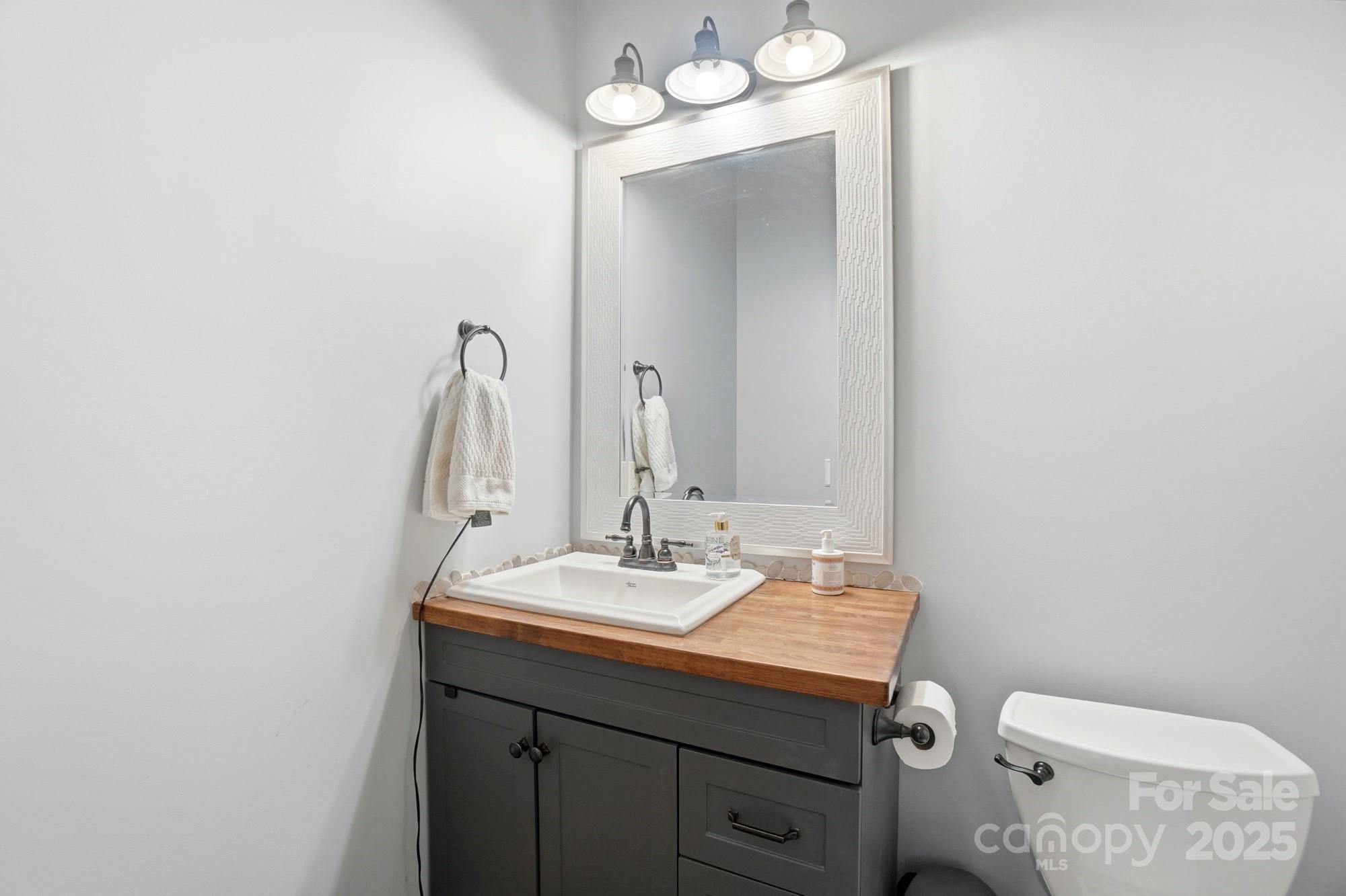 5617 Fairview Road, Unit 5 Charlotte, NC 28209 - Photo 17 of 26 a bathroom with a sink and a toilet